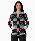 A woman modeling a black zip-front jacket with a colorful cartoon pattern of toothbrushes, toothpaste tubes, and dental tools on a white studio background.