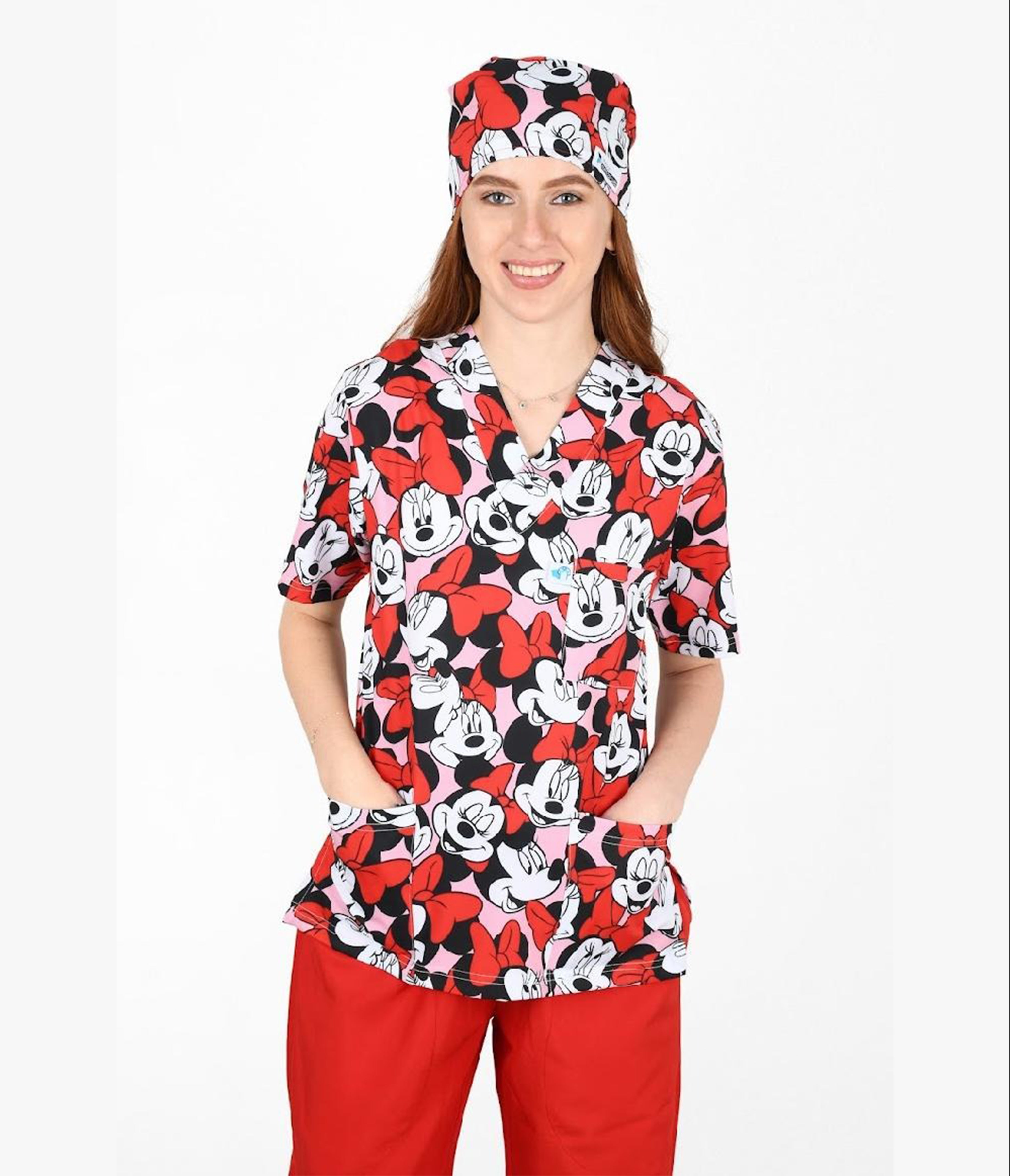 Female healthcare worker wearing Minnie Mouse printed scrub top and matching surgical cap.