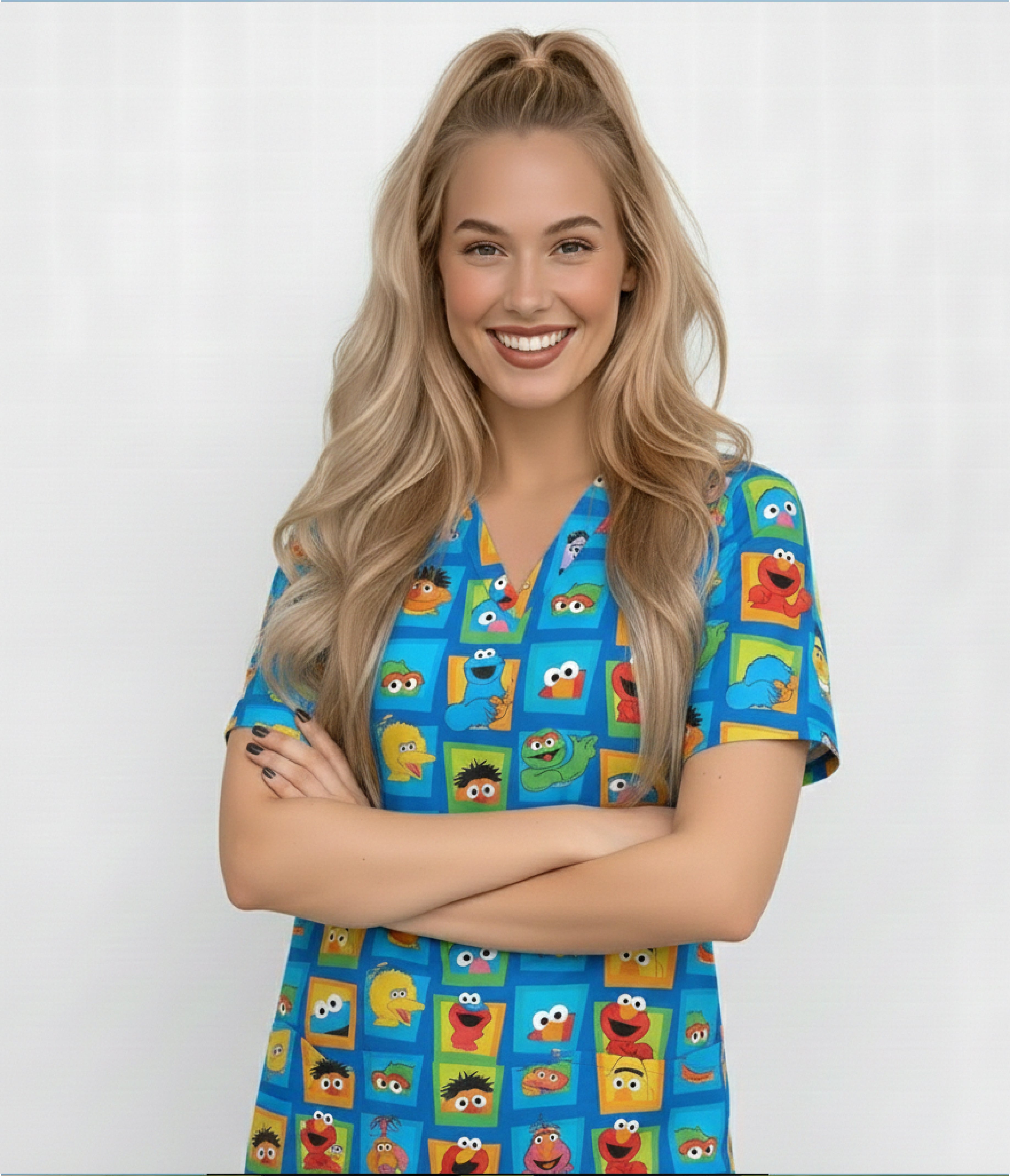 Smiling female healthcare worker wearing blue scrub top with colorful cartoon character print in square pattern.
