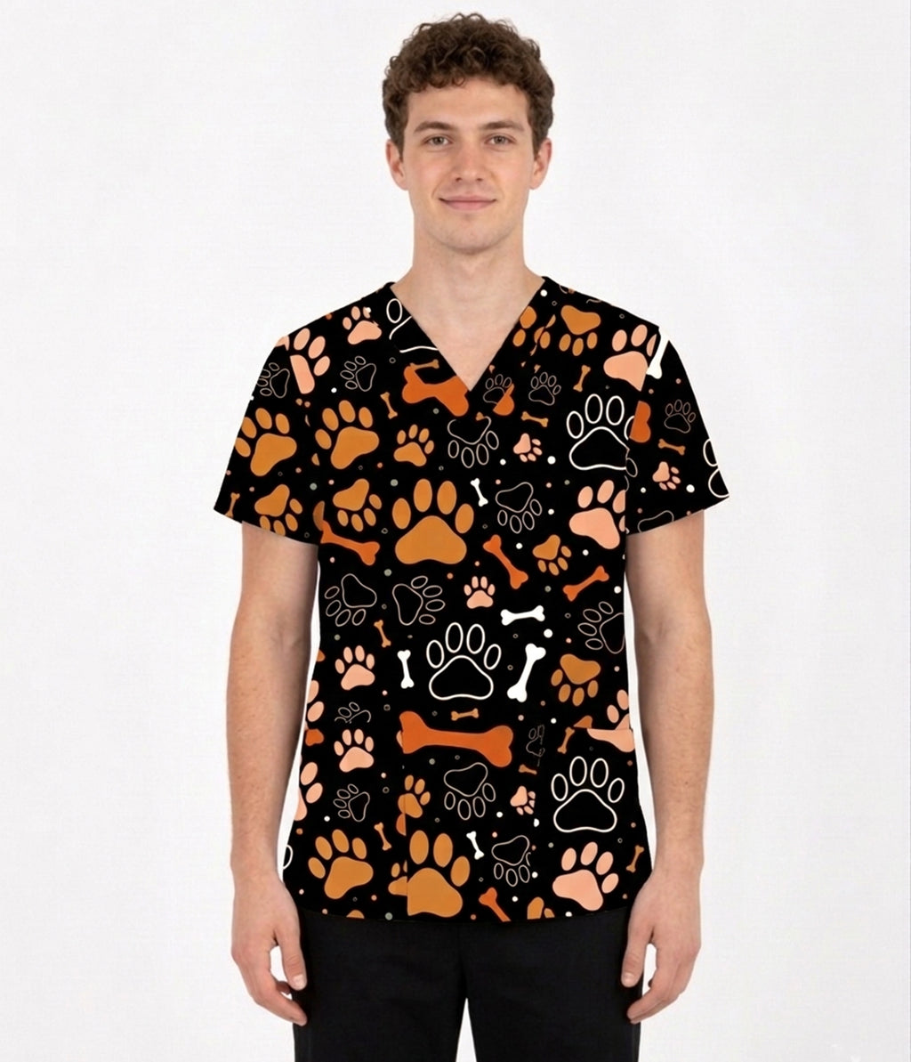 Male model wearing Paws & Bones pet lover scrub top with orange paw prints and bone pattern.