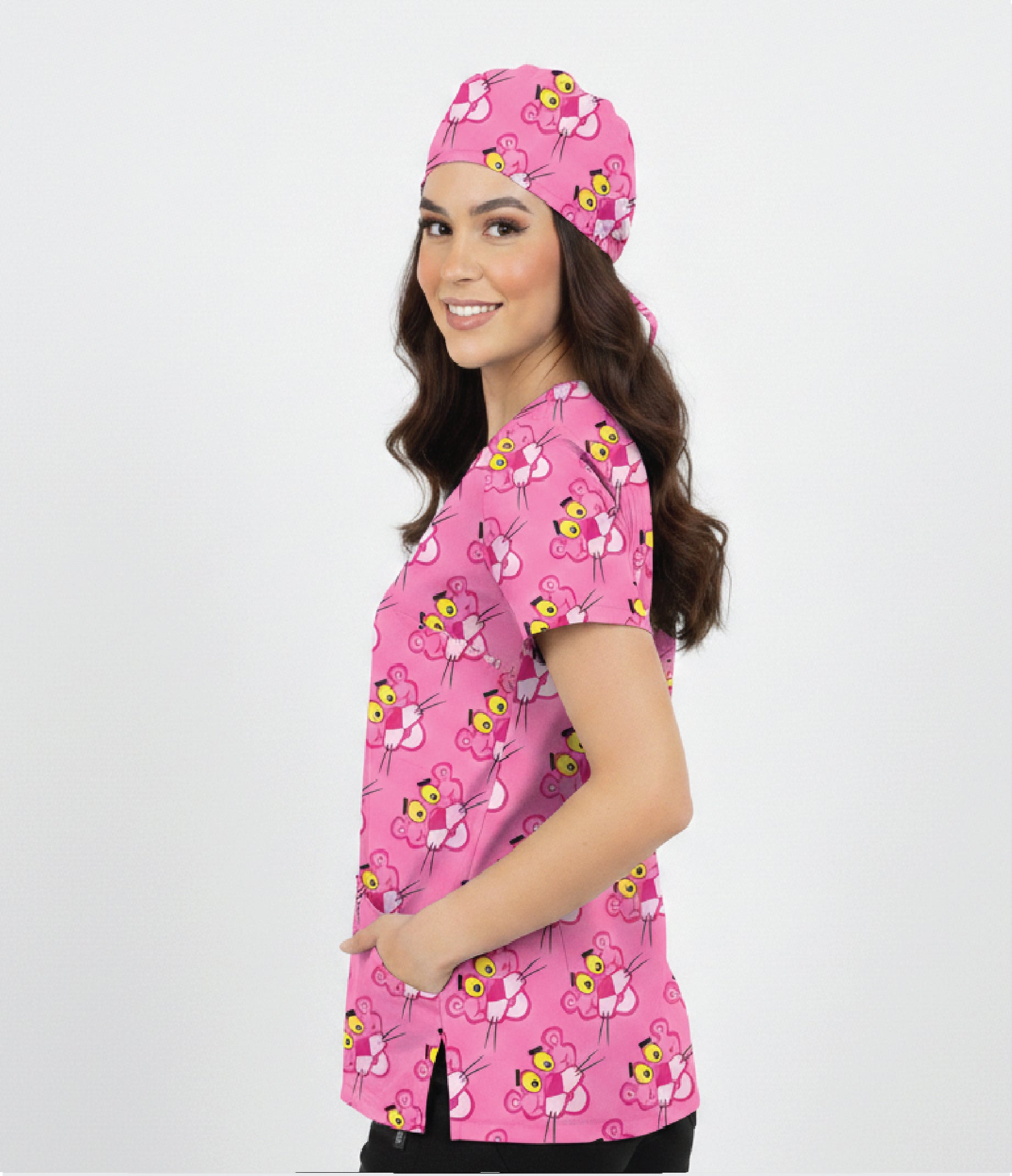 Person wearing a pink scrub top and matching headscarf with butterfly pattern on a white background