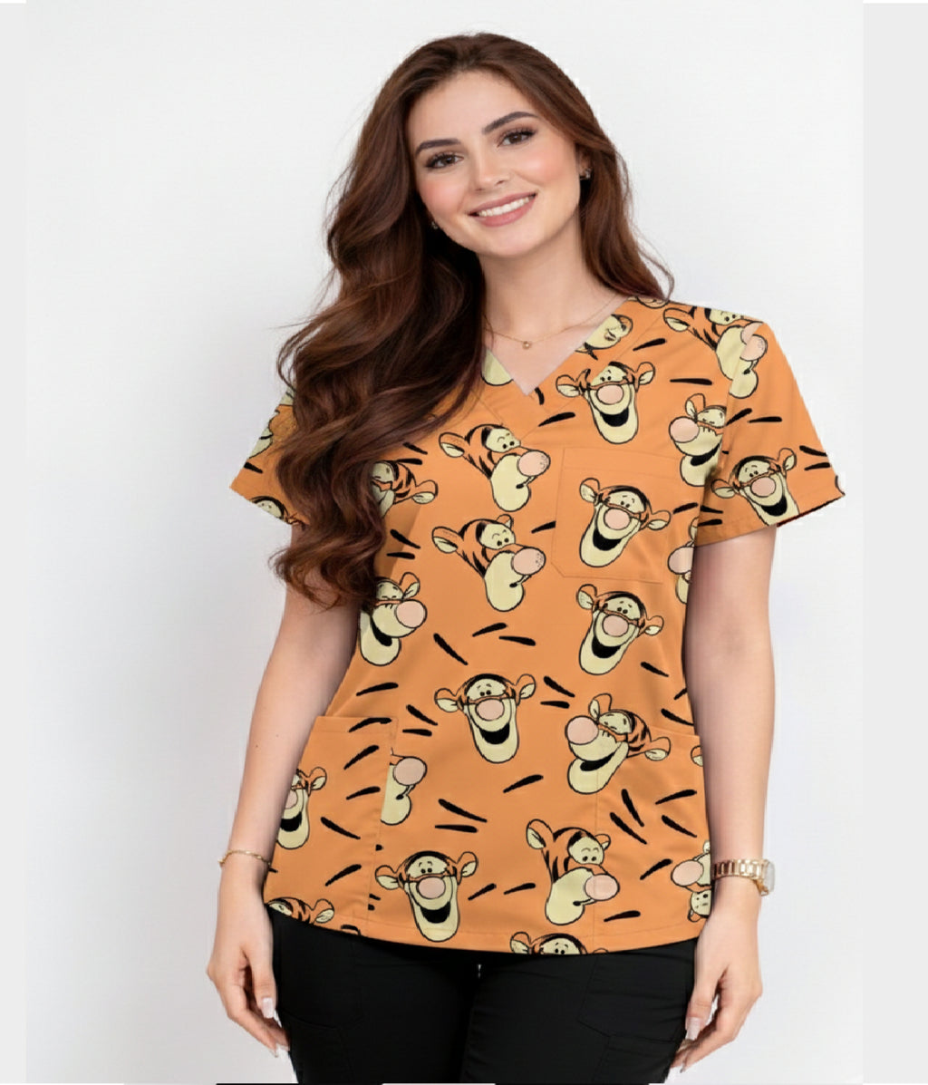 Female healthcare professional wearing blue pediatric dental printed scrub top with tooth and dental tool pattern.