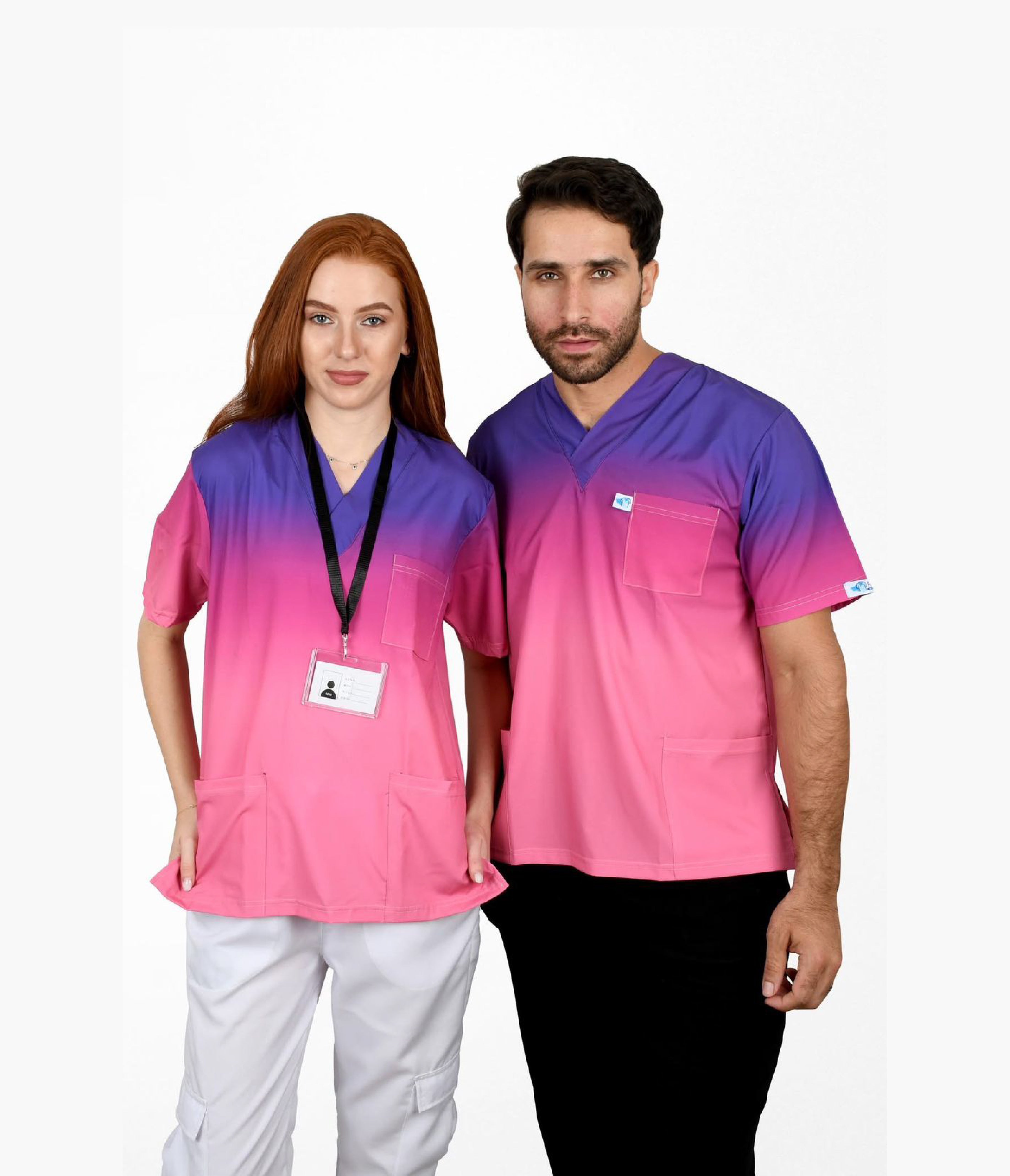 Male and female healthcare professionals wearing pink and purple ombre scrub tops in studio.